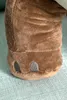 A close-up view of the foot of a brown plush dinosaur toy. Náhled obrázku produktu