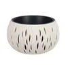 A white planter with a textured, wavy pattern and cutouts, revealing a black interior. The planter is shown against a plain white background. Náhľad obrázku produktu
