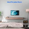 A TV is mounted on a wall above a floating media console in a bedroom setting, with a bed in the foreground. Produktbild-Vorschau
