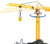 A yellow toy construction crane with a bucket hanging from its hook, shown against a white background. The crane is depicted with a blue arrow indicating rotation. Náhľad obrázku produktu