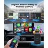 A hand holding a smartphone connected wirelessly to a car's infotainment system, showcasing various apps like maps, music, and phone. Produktbild-Vorschau