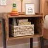 A bedside table with a stacking toy, a framed picture, and a basket of items. Podgląd zdjęcia produktu