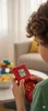 A child is playing a handheld electronic game console. Náhled obrázku produktu