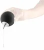 A hand wearing a white glove is holding a black spherical soap dispenser, from which liquid is being dispensed. Produktbild-Vorschau