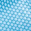 A close-up view of a blue pool cover with a bubble pattern. Voir les images du produit