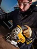 A person is using a DeWALT jigsaw outdoors, possibly in a workshop or shipyard. Produktbild-Vorschau