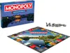 A Monopoly board game box and board are displayed on a white background, along with game pieces. Produktbild-Vorschau