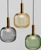 Three pendant lights in different colors (gray, yellow, green) with gold accents, suspended against a light gray background. Anteprima dell’immagine prodotto