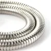 A close-up, studio shot of a coiled metal hose against a white background. Produktbild-Vorschau