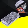 A metal electronic component with wires, shown on a black and yellow background. Náhled obrázku produktu