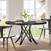 A round dining table set for a meal, with chairs and a floral centerpiece, in a well-lit room with large windows. Anteprima dell’immagine prodotto