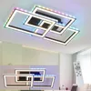 A modern, geometric LED ceiling light fixture with multiple interlocking rectangular frames, illuminated with colorful RGB lights and white light. A remote control is shown in the foreground. Anteprima dell’immagine prodotto