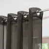 Close-up of brown sheer curtains with grommets hanging from a metal rod. Produktbild-Vorschau