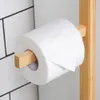 A close-up shot of a toilet paper holder with a roll of toilet paper on it, set against a tiled wall. Náhled obrázku produktu