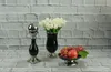 A still life arrangement of decorative items on a brick-patterned surface. Produktbild-Vorschau