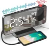 A digital alarm clock with a projected display and a smartphone charging on its base. Produktbild-Vorschau