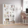 A white bookshelf filled with various decorative items and books, placed in a room with a desk and chair. Produktbild-Vorschau
