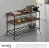 A kitchen shelf unit with kitchenware and a microwave on it, placed in a kitchen setting. Produktbild-Vorschau