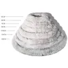 A fluffy, grey dog bed is shown in stacked layers to indicate different sizes, with measurement lines and labels on the left side. Produktbild-Vorschau