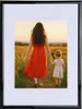 A woman and a child walking in a field of flowers. Produktbild-Vorschau