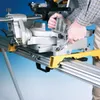 A person is using a miter saw on a stand. Náhled obrázku produktu