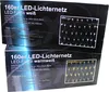 Two boxes of LED net lights are stacked on top of each other. The top box is for white LEDs and the bottom box is for warm white LEDs. Both boxes show a picture of the net lights. Náhľad obrázku produktu