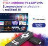 A TV screen displaying a streaming interface, a remote control, and a streaming stick, with colorful smoke effects in the background. Náhled obrázku produktu