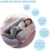 A woman is sleeping comfortably on a large U-shaped pregnancy pillow. Náhled obrázku produktu