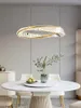 A modern dining room with a marble-topped table and a crystal chandelier. Anteprima dell’immagine prodotto