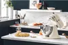 A kitchen counter with a stand mixer, dough, and baked goods. Produktbild-Vorschau