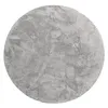 A round, grey rug with a textured, shaggy surface. Voir les images du produit