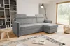 A modern living room with a sectional sofa, bookshelf, and a large window.