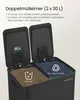 A close-up view of a black double trash can with its lids open, showing two compartments for waste separation. Produktbild-Vorschau
