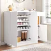 A white shoe cabinet with open doors, displaying shoes and boots on shelves. Anteprima dell’immagine prodotto