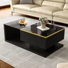 A modern black coffee table with a glass top, placed in a living room setting with a cream-colored sofa in the background. Produktbild-Vorschau