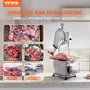 A commercial bone cutting machine is shown in a kitchen setting, with various types of meat and fish displayed around it. Náhled obrázku produktu