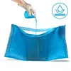 A hand wearing a glove pours liquid onto a blue pet training pad. Náhľad obrázku produktu