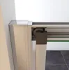 A close-up view of a shower door mechanism, showing the roller and track system. Produktbild-Vorschau