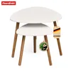 A set of two nesting tables with white tops and wooden legs, displayed on a white background. Anteprima dell’immagine prodotto