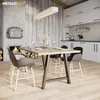 A dining room with a fireplace, a table and chairs, and kitchen cabinets. Podgląd zdjęcia produktu