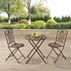 A metal bistro set with a round table and two chairs is placed on a wooden deck in a garden setting. Anteprima dell’immagine prodotto