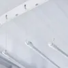 Three white clothes drying rods hanging from a white ceiling track. Anteprima dell’immagine prodotto