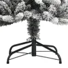 Close-up of the base and lower branches of a flocked artificial Christmas tree. Voir les images du produit