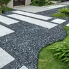 A garden path made of stone and concrete slabs, bordered by grass. Náhled obrázku produktu