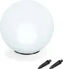 A white spherical solar light for the garden with two black ground spikes in the foreground. Produktbild-Vorschau