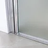 A close-up view of the bottom section of a shower door, showing the track and frame. Náhled obrázku produktu