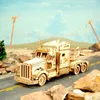 A wooden model of a heavy truck is shown on a road with a desert-like background and telephone poles. Náhľad obrázku produktu