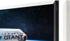 A television screen displaying a space scene with a spacecraft in the foreground, next to a white stand with Samsung branding. Produktbild-Vorschau