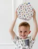 A young boy is holding a craft set above his head. Produktbild-Vorschau