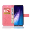 A pink flip phone case with a floral design, holding credit cards and euro banknotes, with a smartphone inside. Produktbild-Vorschau